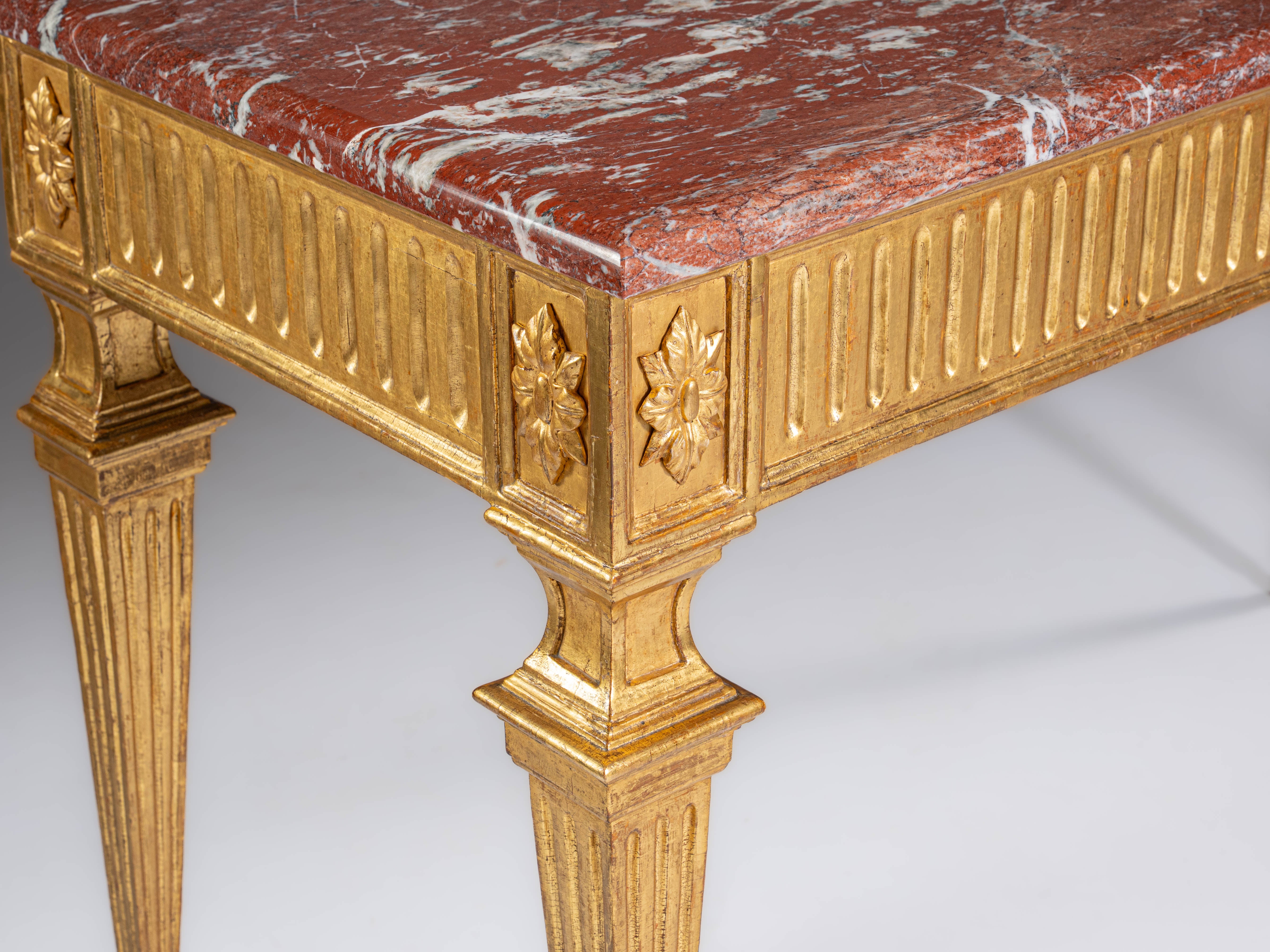 Italian console table in fine gold-gilded wood with a red marble top. Italy, 18th century