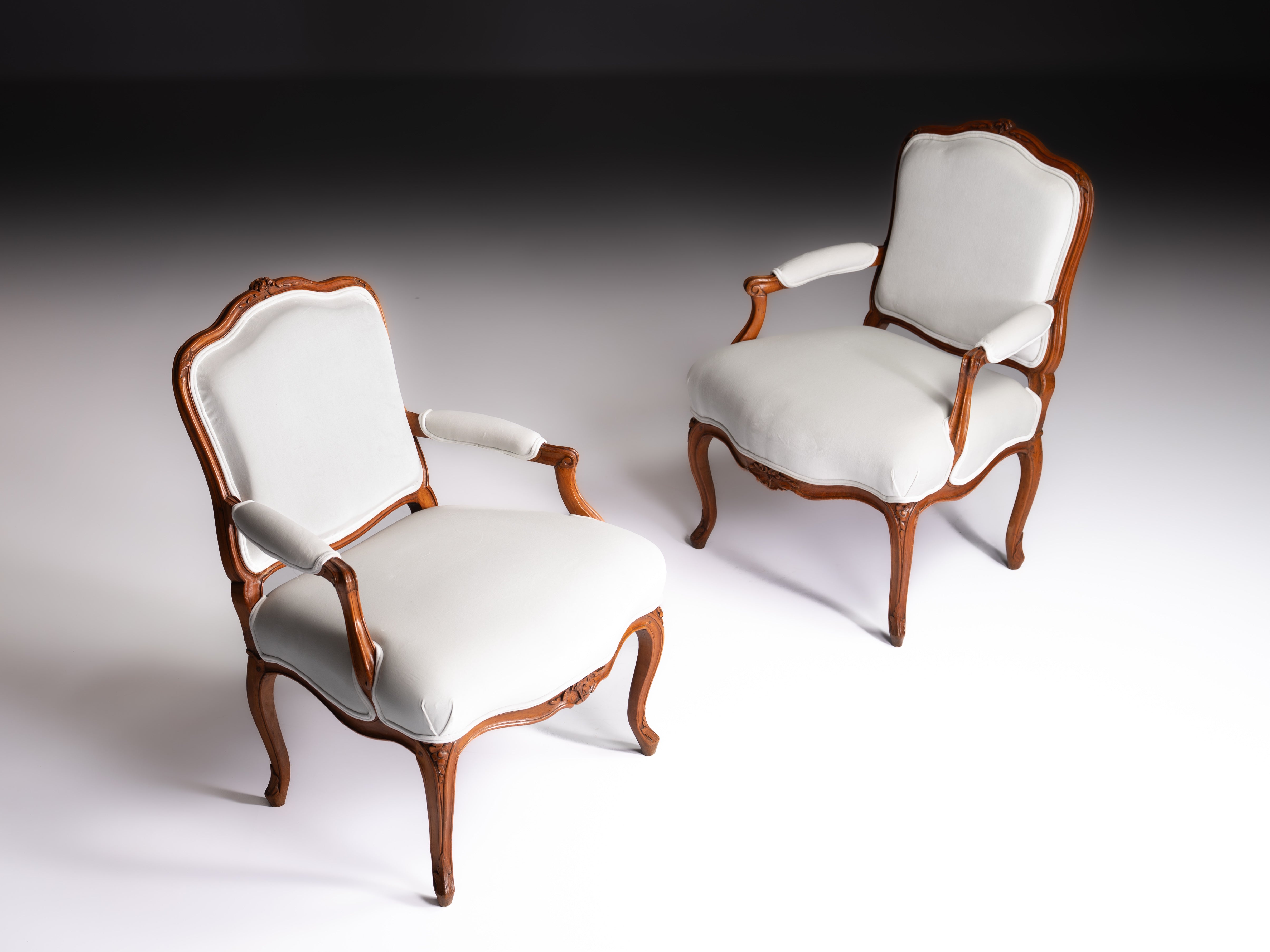 Pair of French Louis XV fauteuils, in finely carved walnut, 18th century