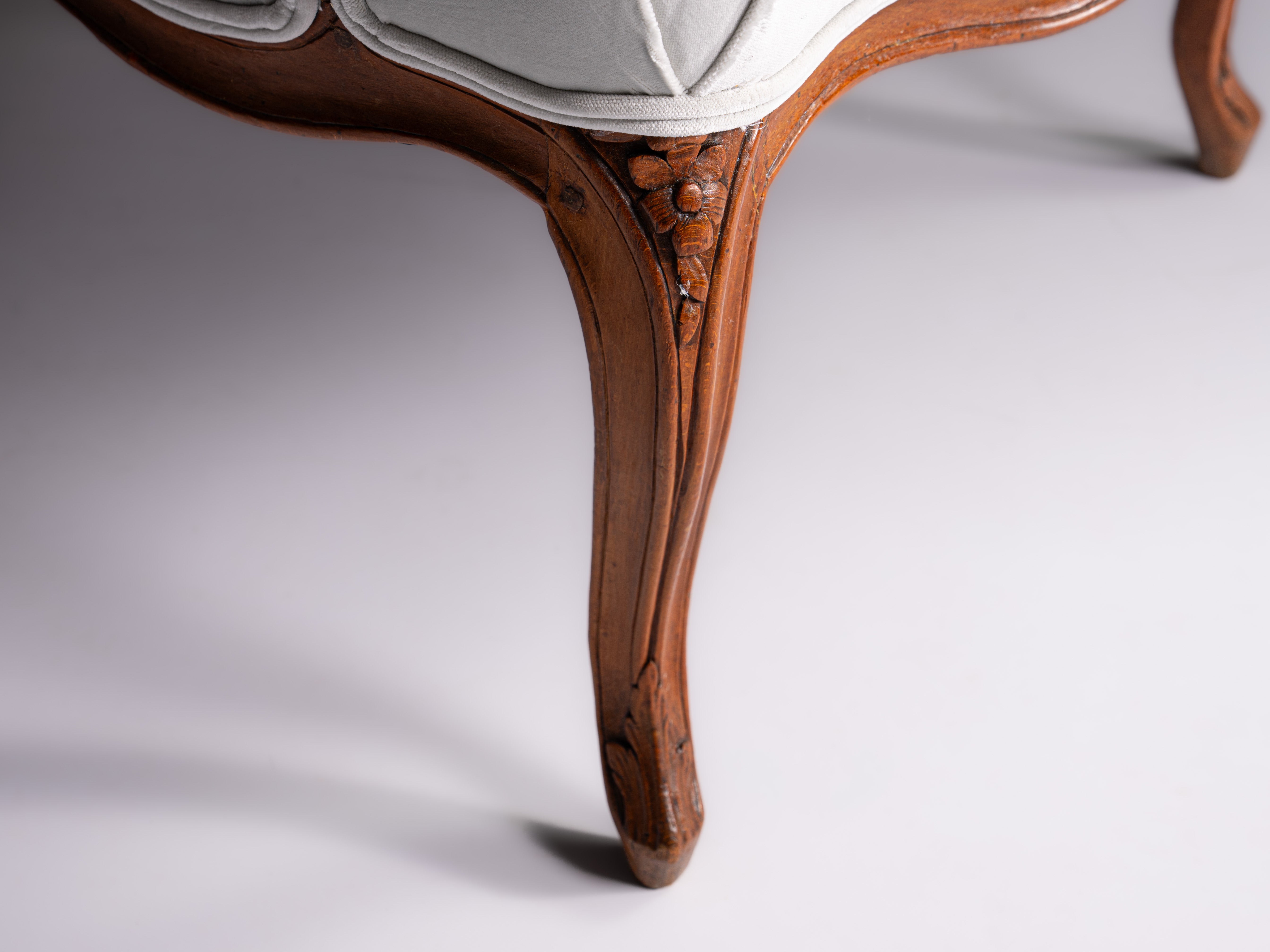 Pair of French Louis XV fauteuils, in finely carved walnut, 18th century