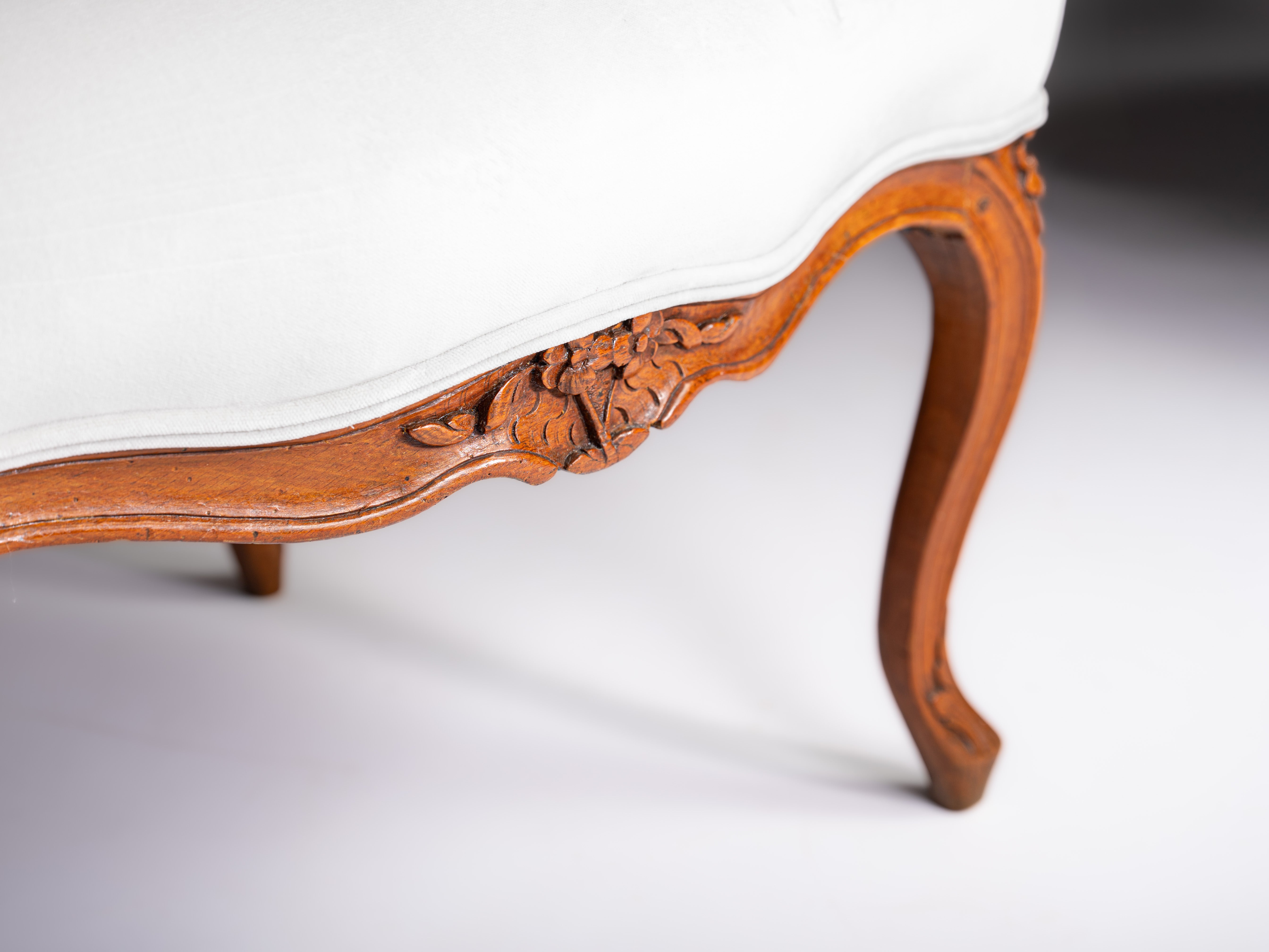 Pair of French Louis XV fauteuils, in finely carved walnut, 18th century